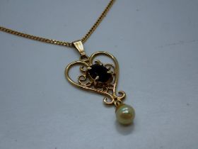 9ct gold pendant necklace set with garnet and seed pearl, pendant unmarked, L: 42 cm, 2.2g. UK P&P