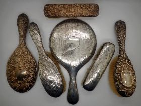 Four hallmarked silver backed brushes and two hallmarked silver mirrors, Chester and Birmingham