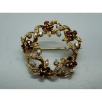 Unmarked yellow gold diamond and ruby set wreath form brooch, D: 30 mm, 7.1g, boxed. UK P&P Group