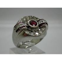 20th century unmarked white gold signet ring set with a large central ruby flanked and surrounded by