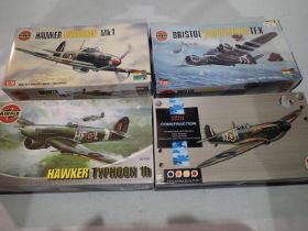 Four 1/72 scale Airfix aircraft kits, Hurricane, Beaufighter, Typhoon, and Spitfire, all appear new,