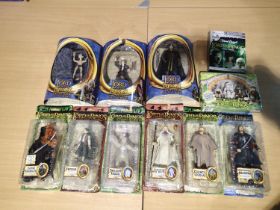 Nine Lord of The Rings figures, all near mint, wear to boxes, plus Trivial Pursuit game and