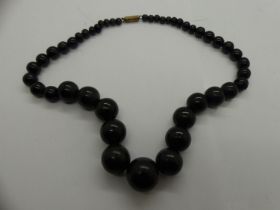 Jet beaded necklace with yellow metal clasp. L: 40 cm. UK P&P Group 0 (£6+VAT for the first lot
