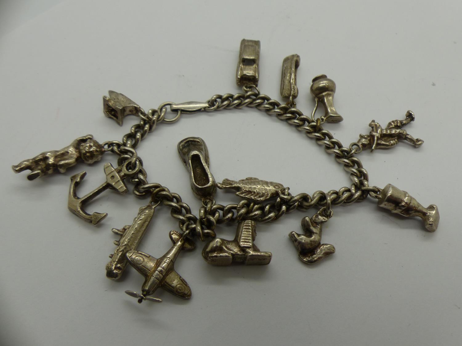 Silver charm bracelet, with fourteen charms, L: 18 cm. UK P&P Group 1 (£16+VAT for the first lot and