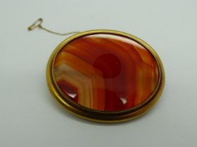 Large Victorian unmarked high-carat gold brooch, set with banded agate, 67 x 55 mm, 35g. UK P&P