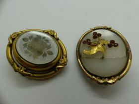 Two yellow metal mounted brooches, one a mourning brooch the other stone set with a cracked stone.