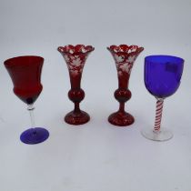 Pair of etched ruby glass vases, one with damages, blue glass wine glass with red twist stem, and