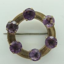 Victorian circular gold brooch set with with six large amethysts, lacking pin catch, unmarked, D: 42