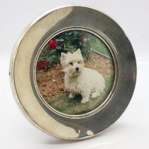 Hallmarked silver circular photograph frame, D: 12cm. Six dents, two of which are more significant