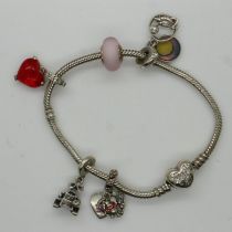 Pandora Disney bracelet with five Disney charms, with box and bag, L: 18 cm. UK P&P Group 1 (£16+VAT