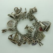 Silver charm bracelet with sixteen charms, 45g, L: 18 cm. UK P&P Group 0 (£6+VAT for the first lot