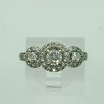 14ct gold diamond set ring, with central stone (0.25ct) flanked by further diamonds and an