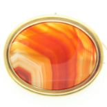 Large Victorian unmarked high-carat gold brooch, set with banded agate, 67 x 55 mm, 35g. UK P&P