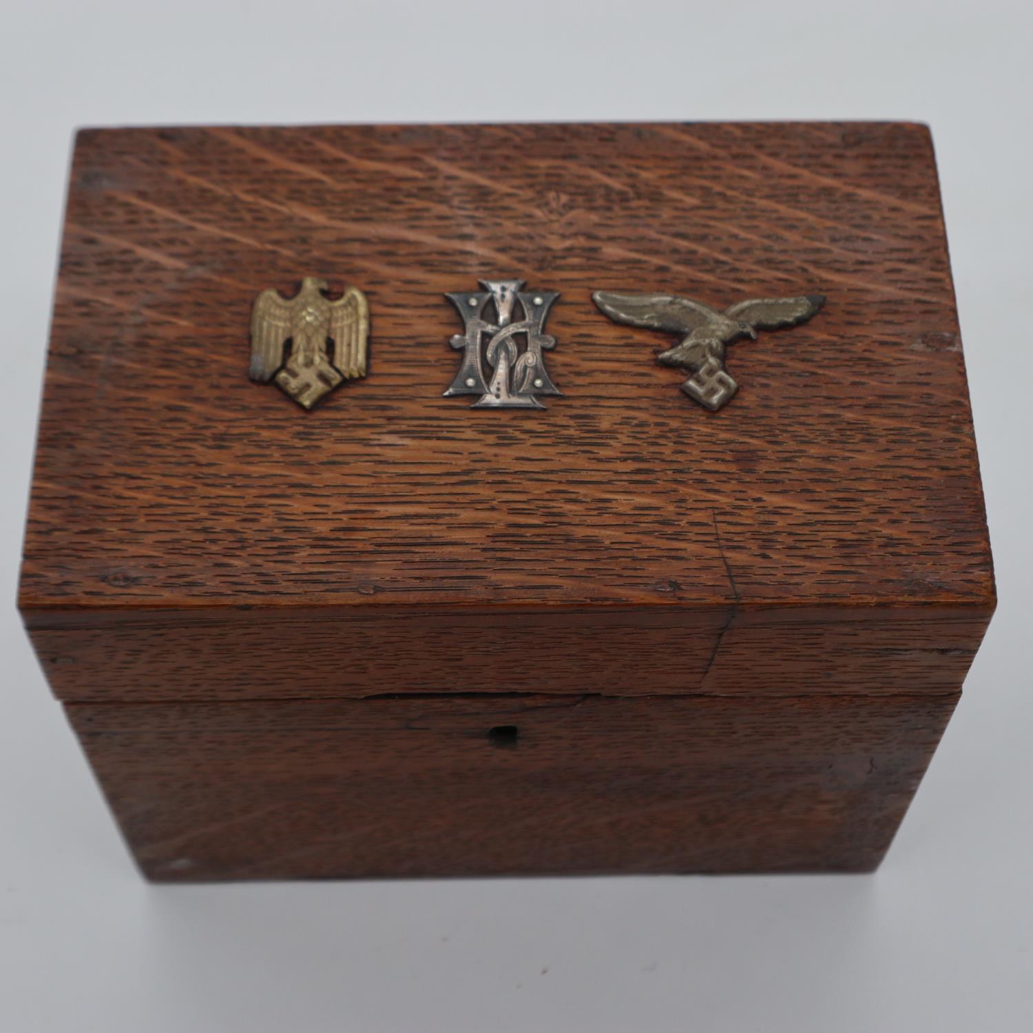 An oak box, affixed with German WWII badges to the hinged cover. UK P&P Group 1 (£16+VAT for the