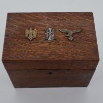 An oak box, affixed with German WWII badges to the hinged cover. UK P&P Group 1 (£16+VAT for the