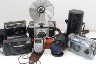 Collection of vintage film cameras and lenses including Minolta, Ilford, Kodak and a waterproof