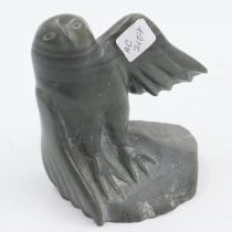 Inuit figure of an eagle perched on a rock, etched figure of a lizard in the rock, ring number to