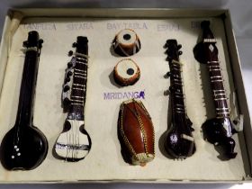 Seven Indian miniature wooden instruments, Largest L: 17 cm. Not available for in-house P&P