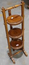 Early 20th century walnut three tier folding plate stand, H: 103 cm. Not available for in-house P&P
