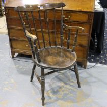 A 19th century elm stick-back country kitchen chair with circular seat and carved supports. Not