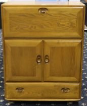 Ercol Windsor Golden Dawn bureau with fall front above two cupboard doors and single drawer, 83 x 45