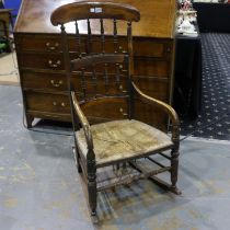 A 19th century country elm rocker, with rushed seat and turned spindle back. Not available for in-