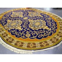 A large oval blue ground rug in the Middle-Eastern manner, 350 x 280 cm, some fringe missing. Not