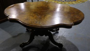 Victorian burr walnut breakfast or loo table with shaped top and carved supports, lacking hinge