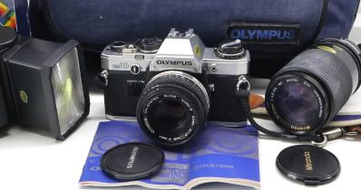 Olympus OM10 with 50mm 1.8 lens, a 70 to 210mm zoom lens and other accessories in Olympus bag. UK