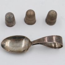 Three hallmarked silver thimbles including a James Walker example, and a hallmarked silver caddy