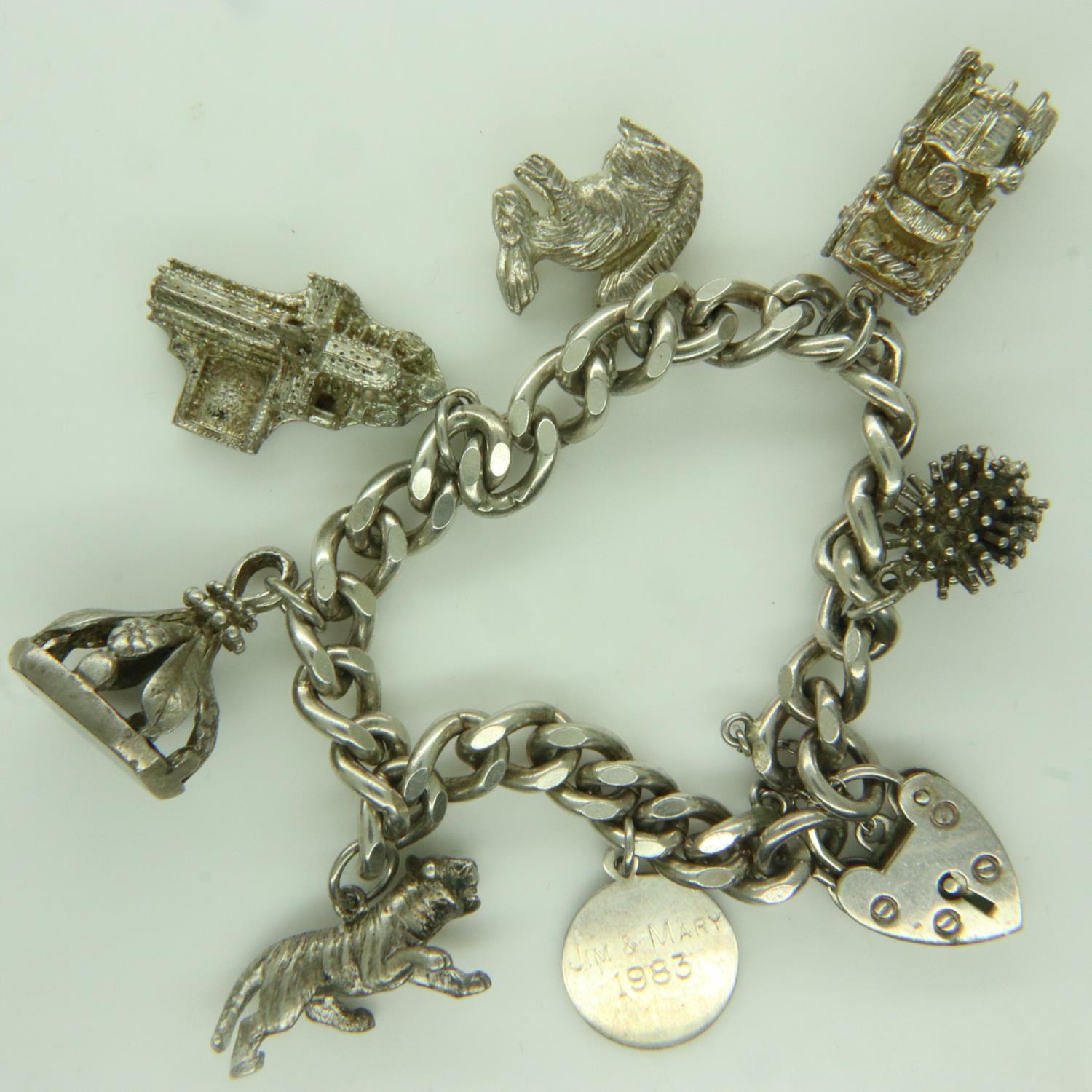 Hallmarked silver charm bracelet with seven charms, L: 18 cm, 62g. UK P&P Group 0 (£6+VAT for the