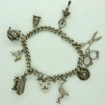 Hallmarked silver charm bracelet with nine charms, 39g. UK P&P Group 0 (£6+VAT for the first lot and