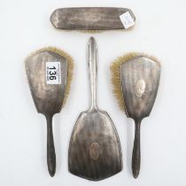 Hallmarked silver backed vanity set comprising a clothes brush, two brushes and a mirror. UK P&P