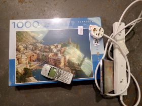 Mixed lot, including a Ronson lighter, sealed jigsaw, CD, mobile phone and an extension cable. Not