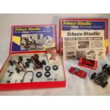 Two Schuco Studio cars, with spanners, lift, spare tyres etc, plus two Schuco micro racers (one