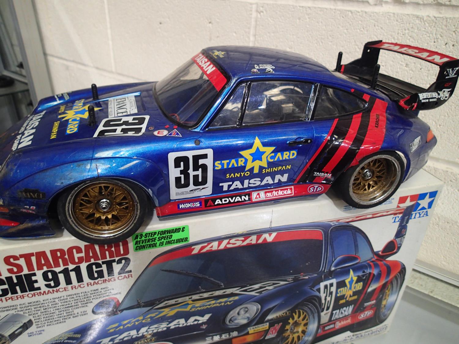 Tamiya 1/10 scale electric Porsche 911 GT2, built and finished, plus radio control spares