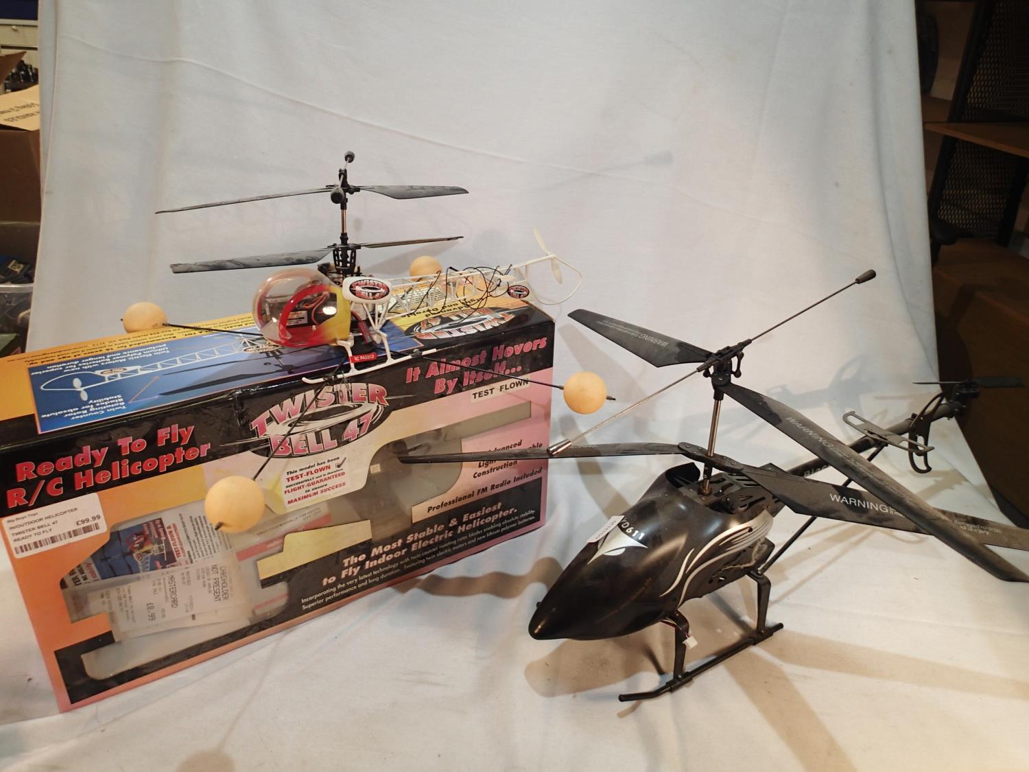 Two radio control helicopters, Twister Bell 47, with transmitter, charger, spare blades, box etc,