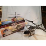 Two radio control helicopters, Twister Bell 47, with transmitter, charger, spare blades, box etc,