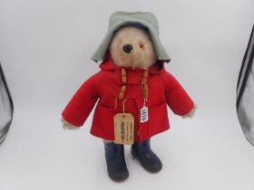 Original Paddington Bear with tag attached, complete with hat, safety pin, duffle coat and Dunlop