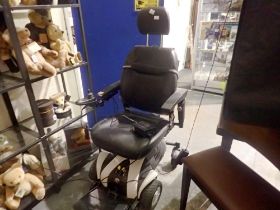 Travelux motorised invalid mobility chair with charger. All electrical items in this lot have been