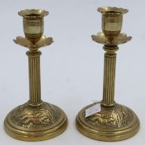 Pair of brass candlesticks with hunting scenes impressed, T&T reg number 65361, H: 17 cm. UK P&P