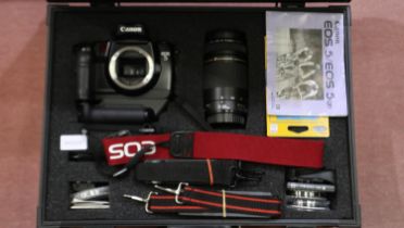 Canon EOS 5 camera setup, including SLR body, Canon Ultrasonic zoom lens, battery grip and other