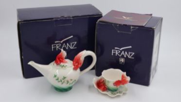 A boxed Franz Porcelaine tea pot in the Goldfish design FZ00442 and a boxed matching tea cup and