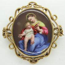 A gold mounted Victorian enamelled brooch, featuring the Madonna and child, unmarked, overall 60 x