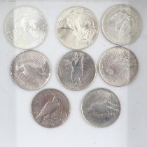 Five silver American peace dollars, one silver Morgan dollar and two Liberty bullion rounds. UK P&