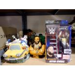 Selection of character money boxes and toys to include Kevin Owens, in box. Not available for in-