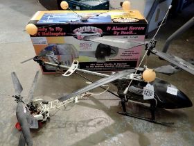 Two radio control helicopters, Twister Bell 47, with transmitter, charger, spare blades, box etc,