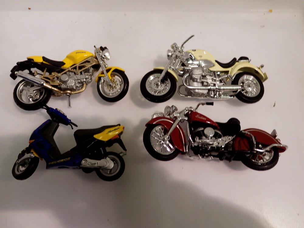 Three Maesto toy motorcycles and a Peugeot scooter toy replica. UK P&P Group 1 (£16+VAT for the