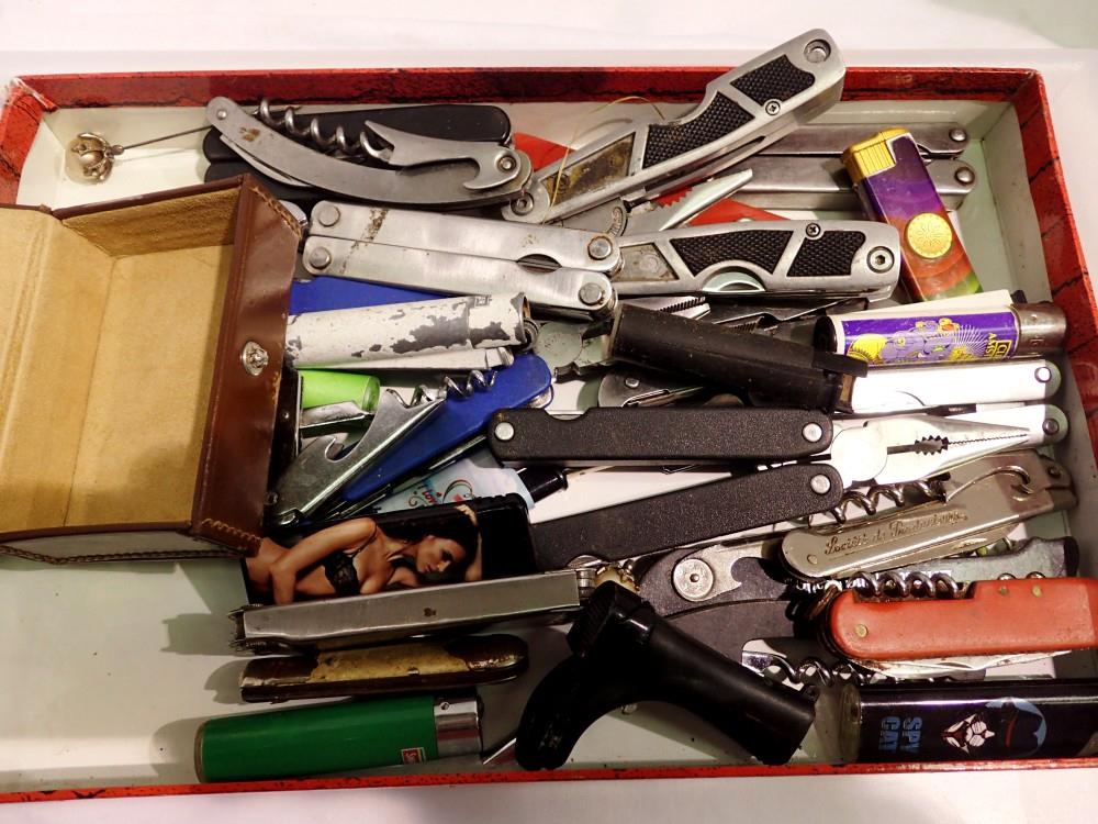 Tray of mixed penknives, lighters and multi tools. Not available for in-house P&P