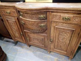 Carved mahogany bow fronted sideboard with four drawers over three cupboards. Not available for in-